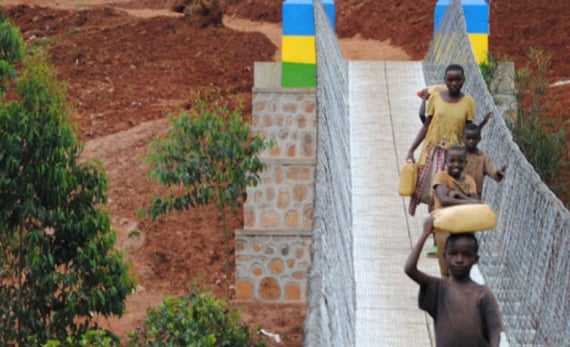 Children from rewanda walking across bridge