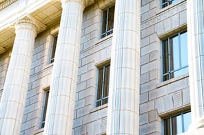 Large white stone building with large columns